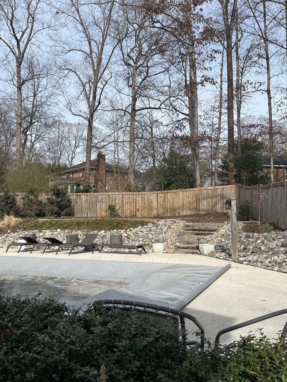 Same backyard completely cleared after Junk Doctors removed the old playset