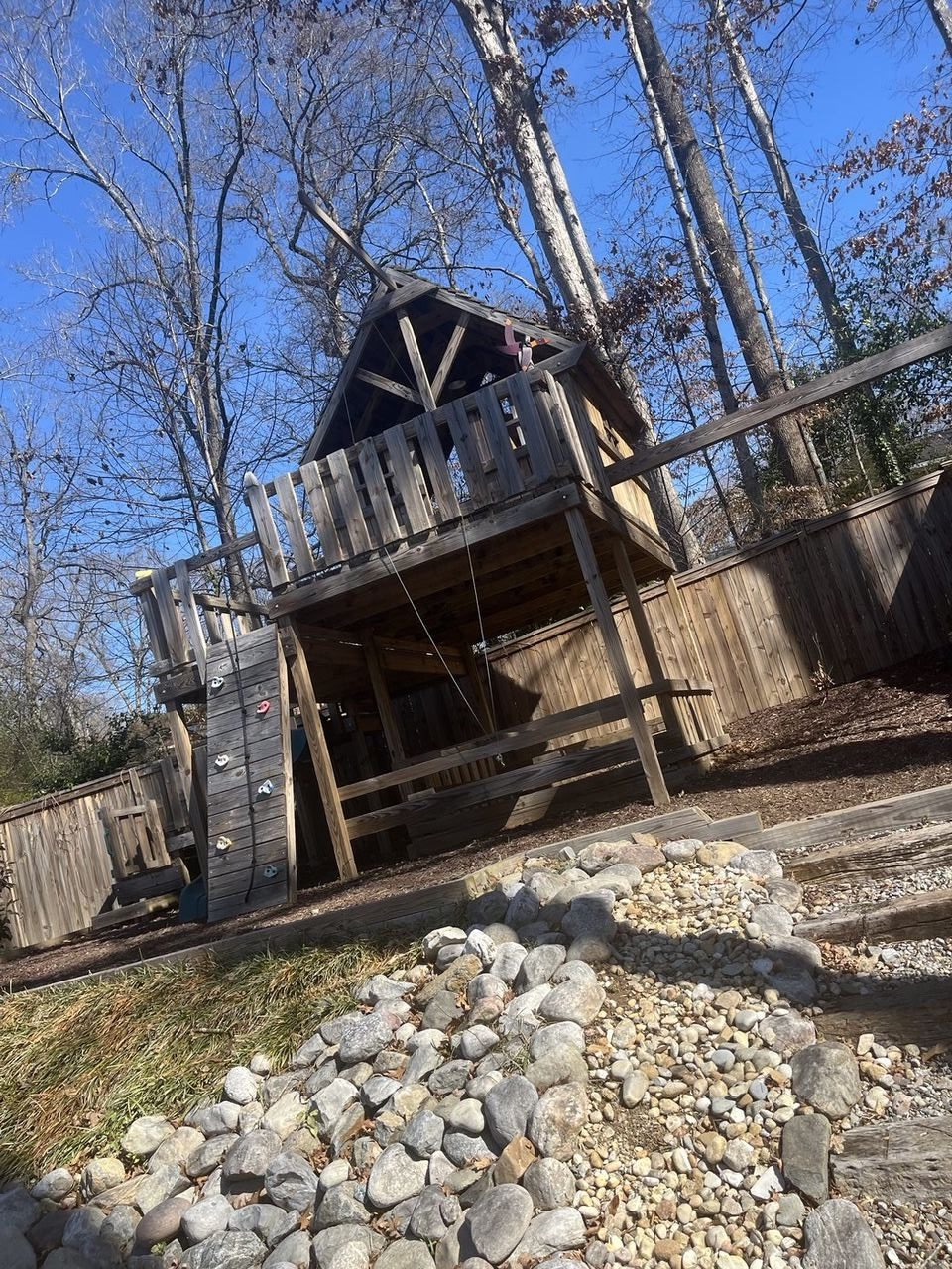 Old rotting playset and wooden structure in backyard — before Junk Doctors demolition